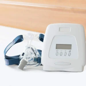 A photo of ResMed AirMini Travel CPAP device, compact and portable, with carrying case on a clean white background.
