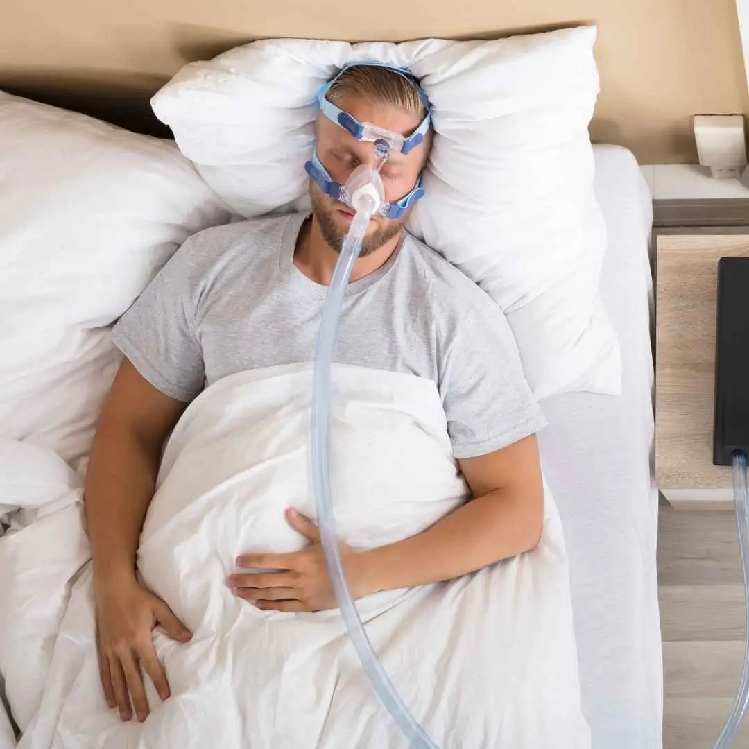Sleep apnea test kit with monitoring device on a bed, used for diagnosing sleep disorders at home.