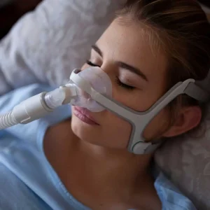 CPAP machine setup on bedside table, showing a common treatment for sleep apnea during nighttime sleep.