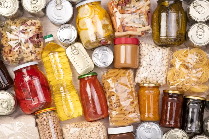 Assortment of preserved foods including canned, dried, and pickled items displayed on a kitchen countertop.